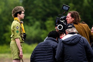 Wes Anderson (behind camera) directs actor Jared Gilman in MOONRISE KINGDOM