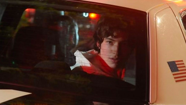 actor Ezra Miller looking out the back window of a Police car in WE NEED TO TALK ABOUT KEVIN movie