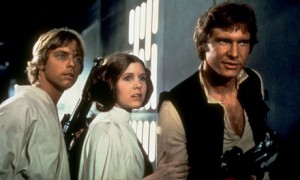 The originals (L-R): Mark Hamill, Carrie Fisher, and Harrison Ford in STAR WARS (1977).