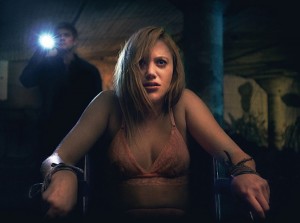 Actress Maike Monroe is tied to a chair in the posters for It Follows horror movie