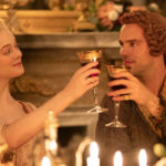Actress Elle Fanning as EmpressCatherine the Empress of Russia and actor Nicholas Hoult as Peter, the Emperor drink a toast in The Great, a HULU TV series