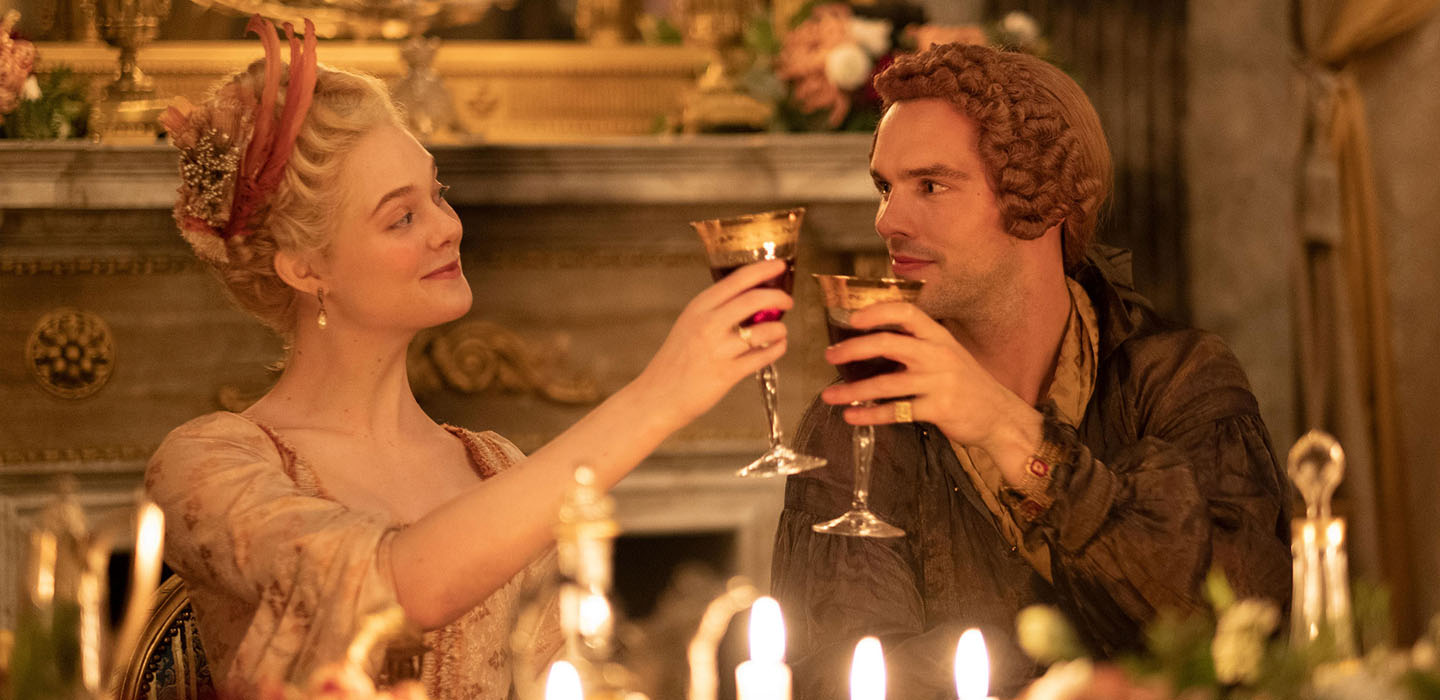 Actress Elle Fanning as EmpressCatherine the Empress of Russia and actor Nicholas Hoult as Peter, the Emperor drink a toast in The Great, a HULU TV series