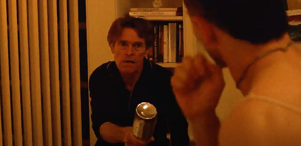 In this still from the film Pet Shop Days, Actor Willem Dafoe is holding a bottle while confronting a young intruder.