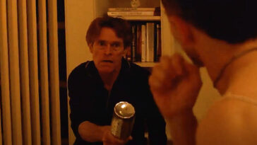 In this still from the film Pet Shop Days, Actor Willem Dafoe is holding a bottle while confronting a young intruder.