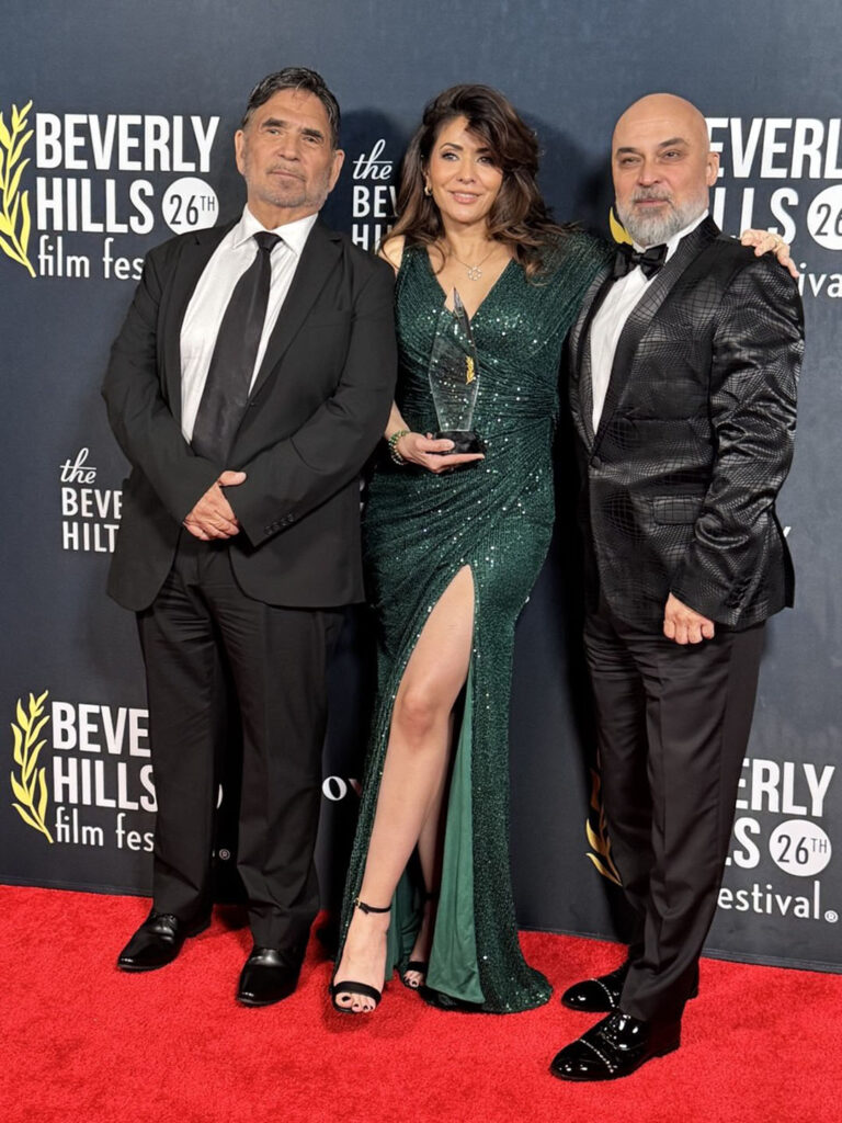 Golsa Sarabi at the Beverly Hills Film Festival 2026 Awards Gala holding Best Screenplay award for The Persian Rug